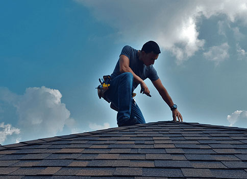 Insurance specialist inspecting roof